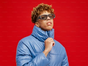 a woman wearing a blue jacket and sunglasses