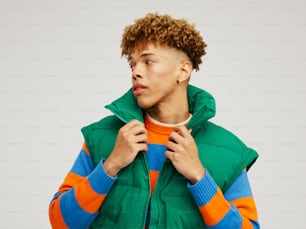 a man in a green, orange, and blue jacket