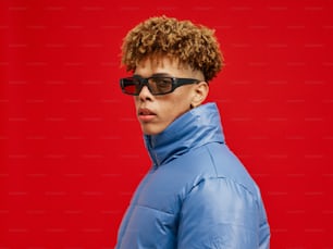 a man wearing sunglasses and a blue jacket