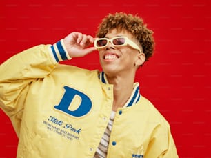 a man wearing a yellow jacket and sunglasses