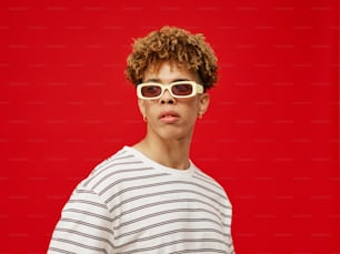 a young man wearing a pair of sunglasses