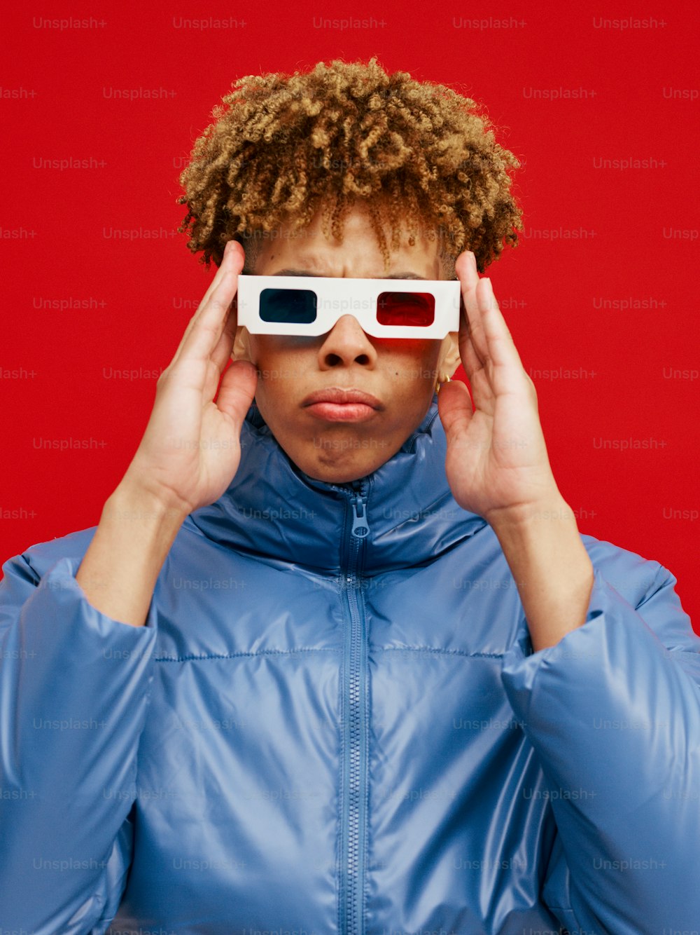 a woman wearing a blue jacket and white 3d glasses
