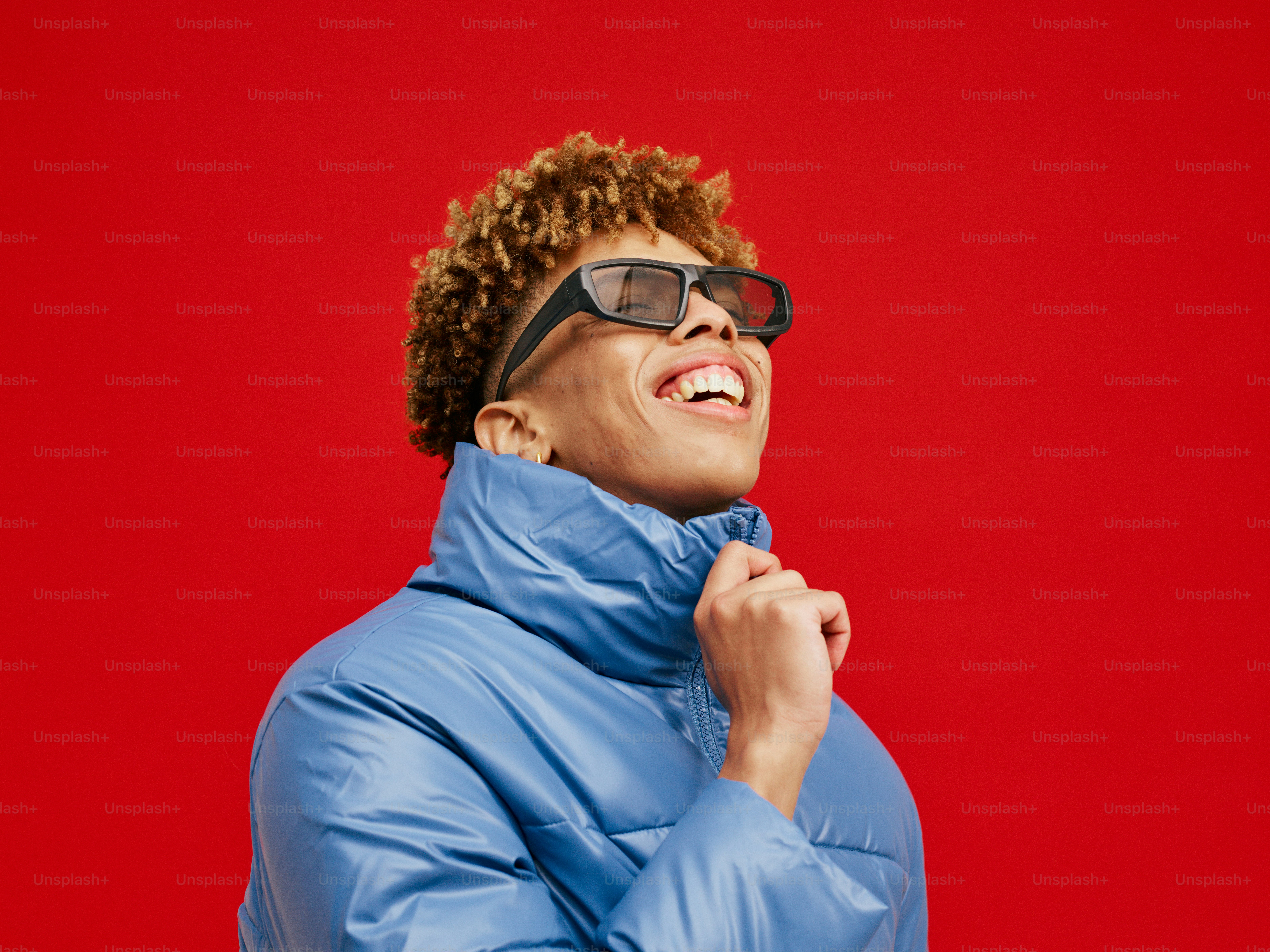 a person wearing a blue jacket and sunglasses