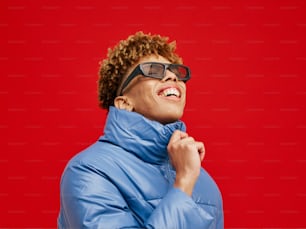 a person wearing a blue jacket and sunglasses