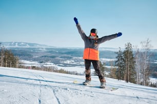 a person riding a snowboard on top of a snow covered slope