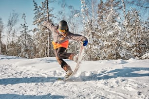 a man riding a snowboard down a snow covered slope