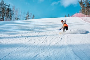 a man riding a snowboard down a snow covered slope