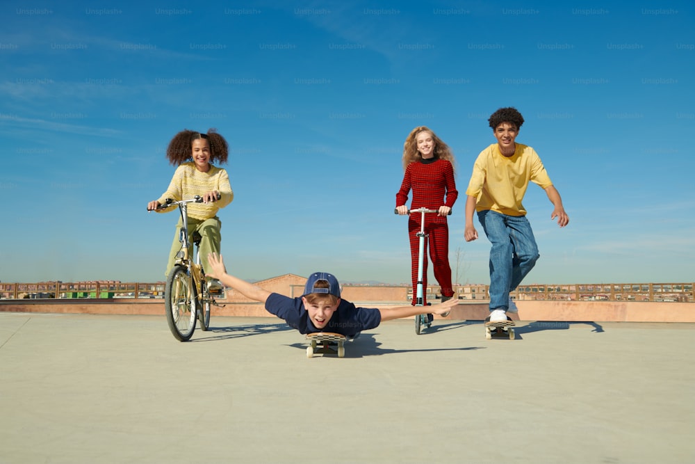 a group of young people riding on top of skateboards