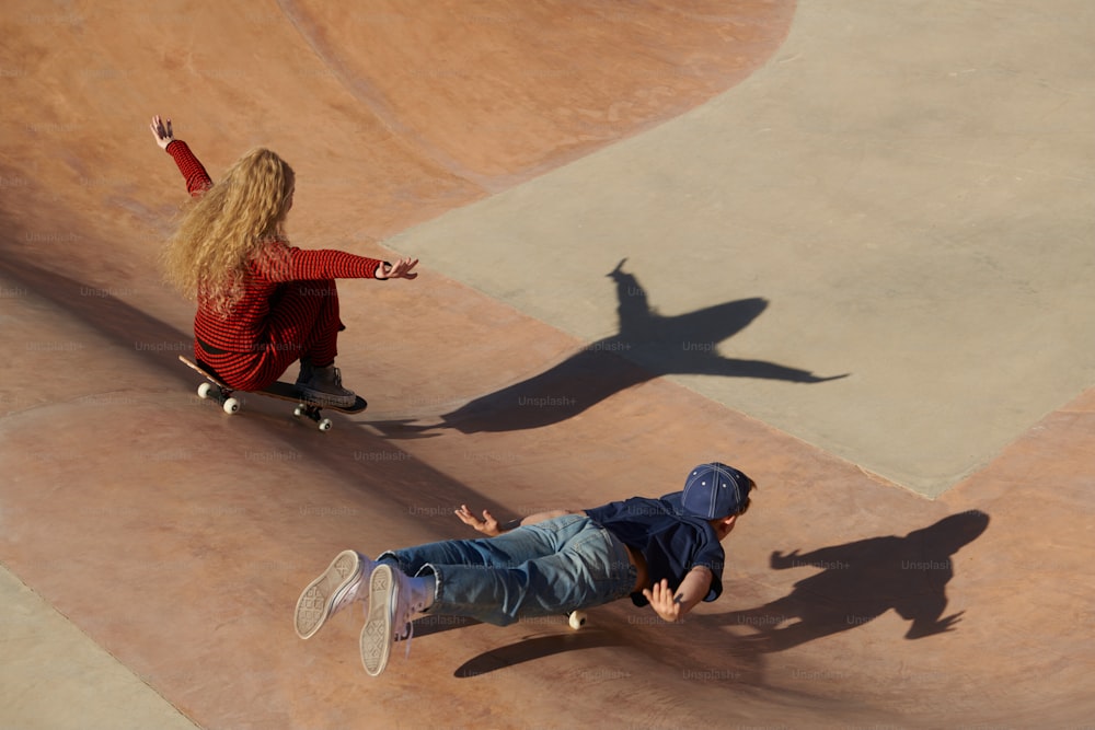 two people riding skateboards at a skate park