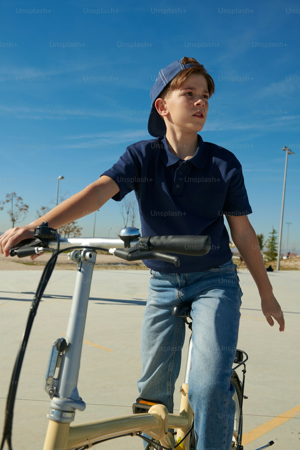 a boy riding a bike in a parking lot