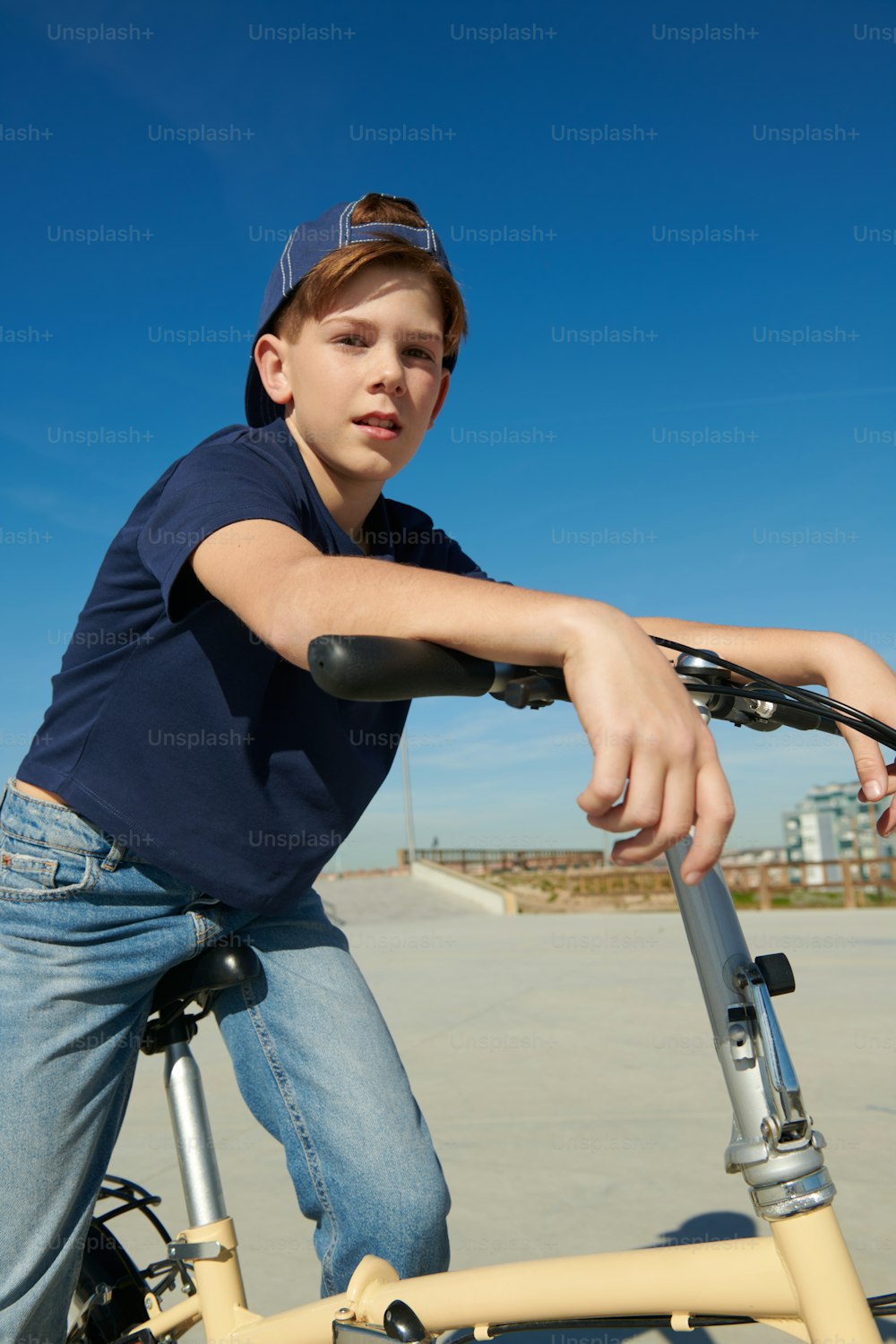 a young boy is riding a bicycle in a parking lot