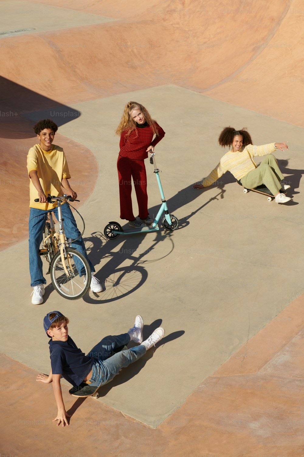 a group of young people riding bikes in a skate park