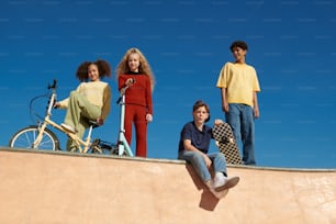 a group of young people standing on top of a skateboard ramp