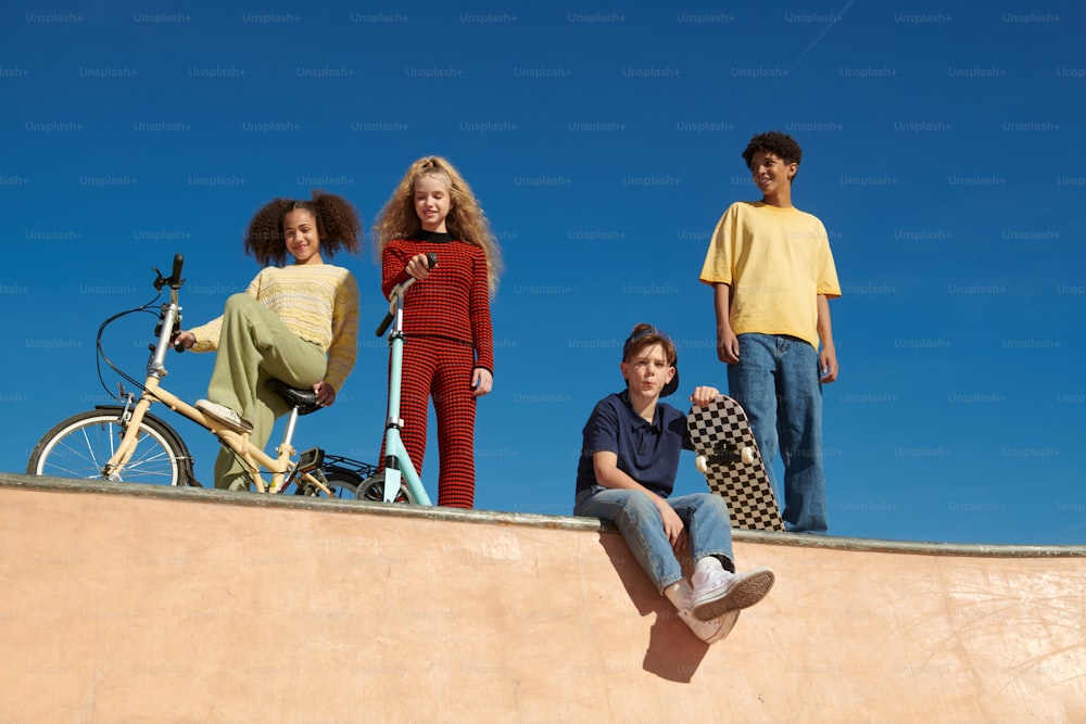 a group of young people standing on top of a skateboard ramp