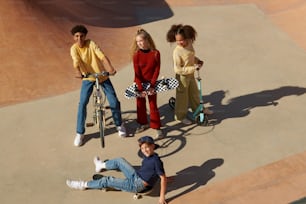 a group of young people standing around a skate park
