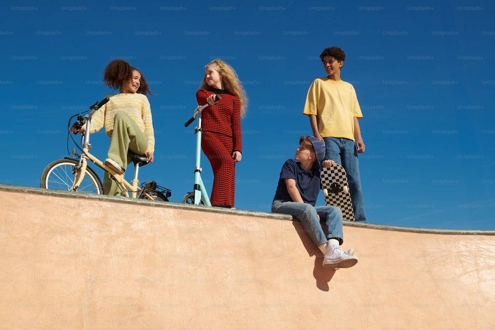 a group of people standing on top of a skateboard ramp