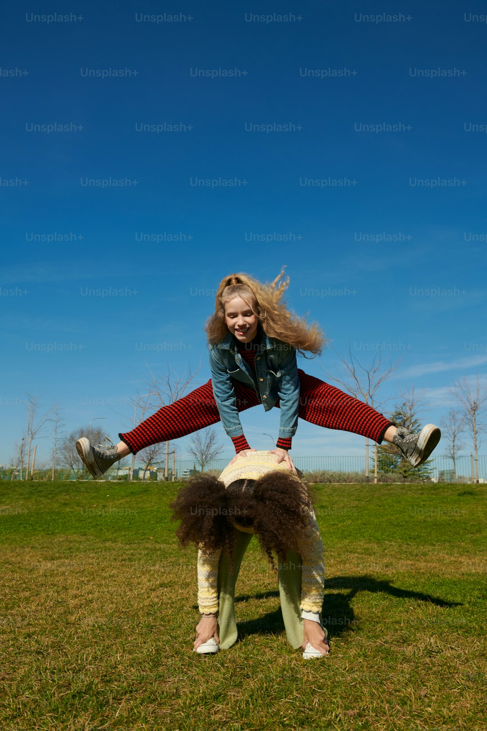 a woman is doing a handstand in the grass