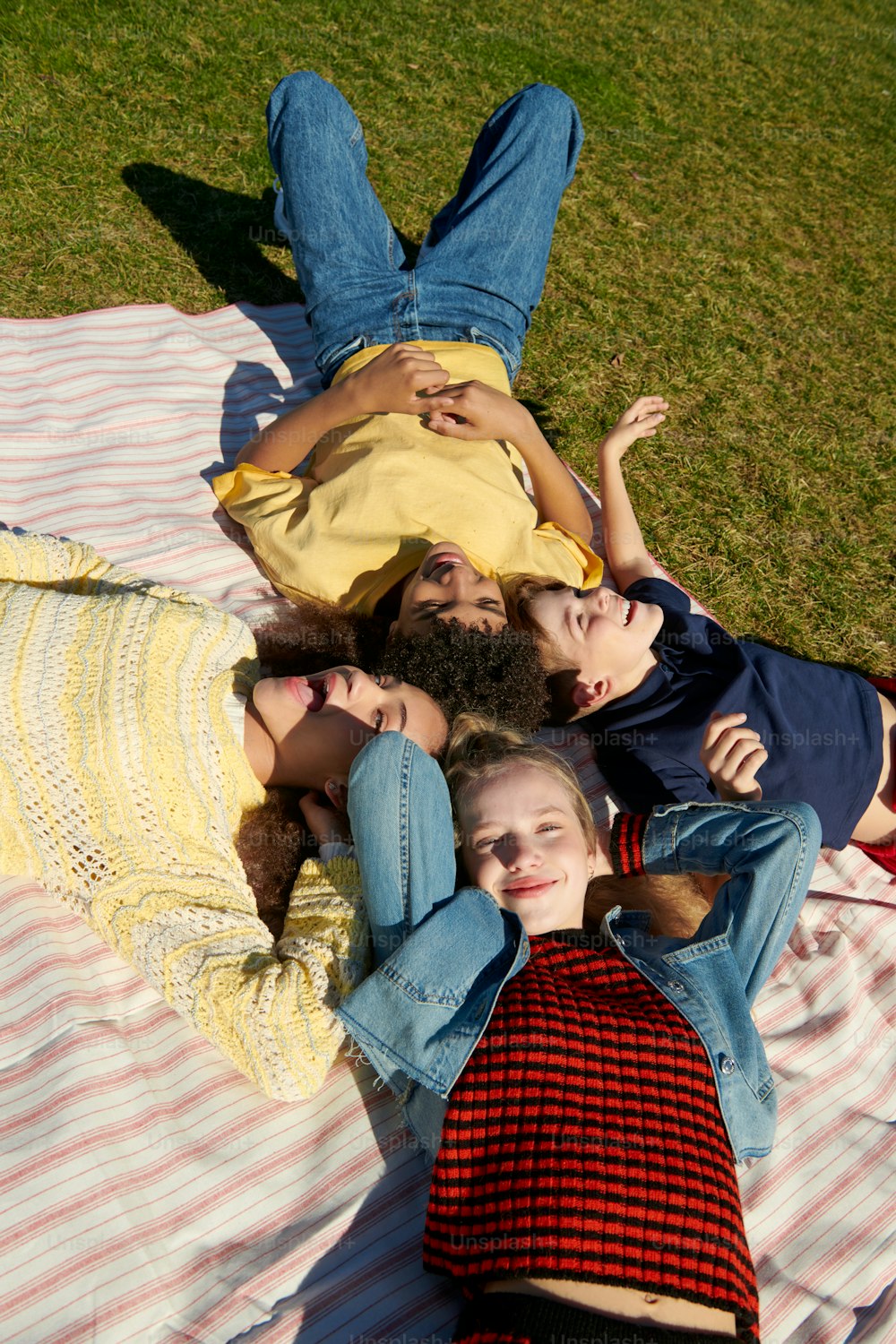 a group of people laying on top of a blanket