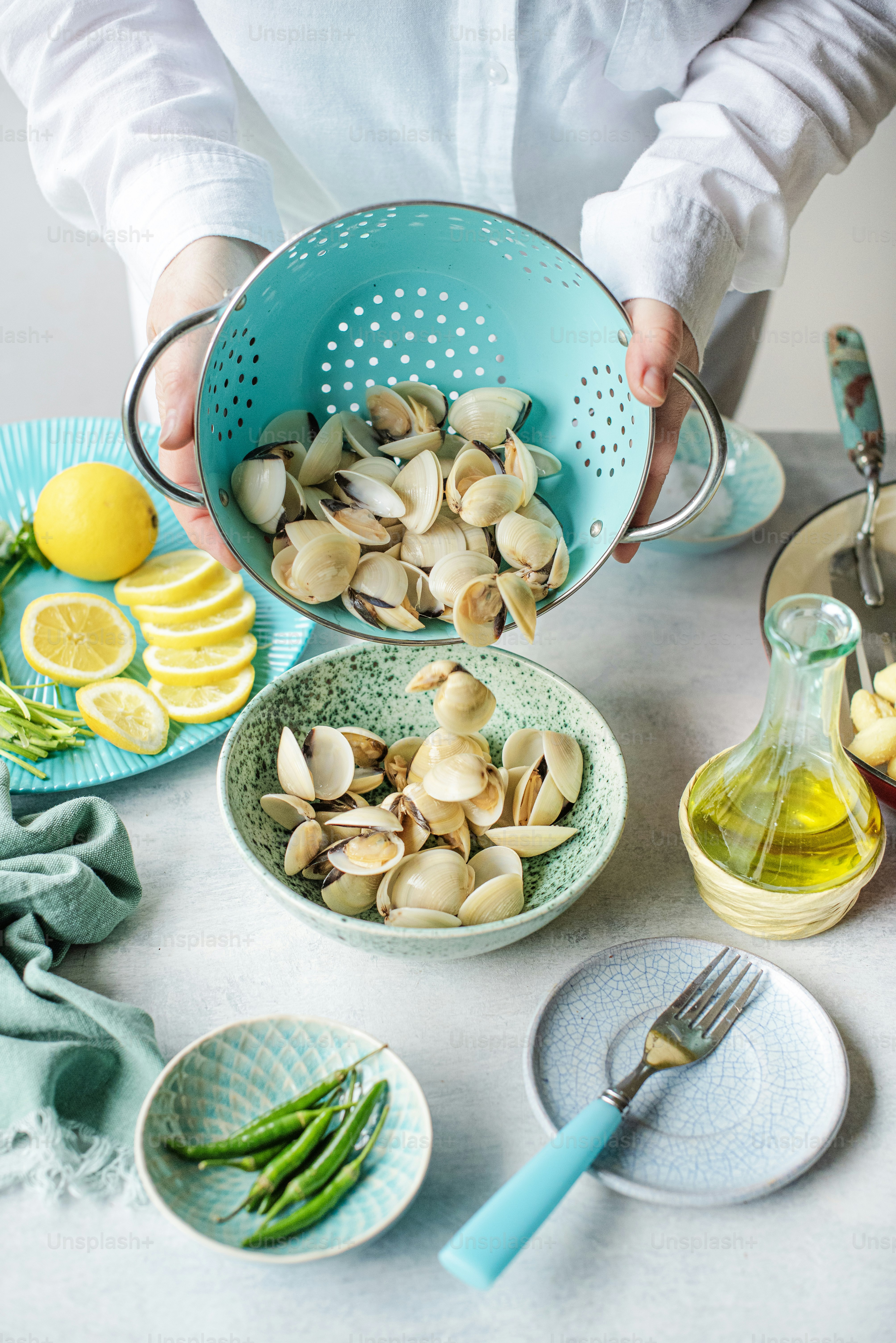 a person pouring a bowl of nuts into a bowl