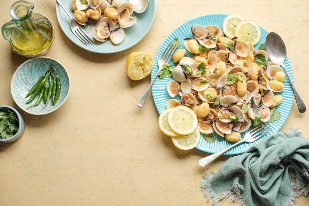 a plate of clams and asparagus on a table