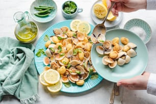 a blue plate topped with clams and lemon slices