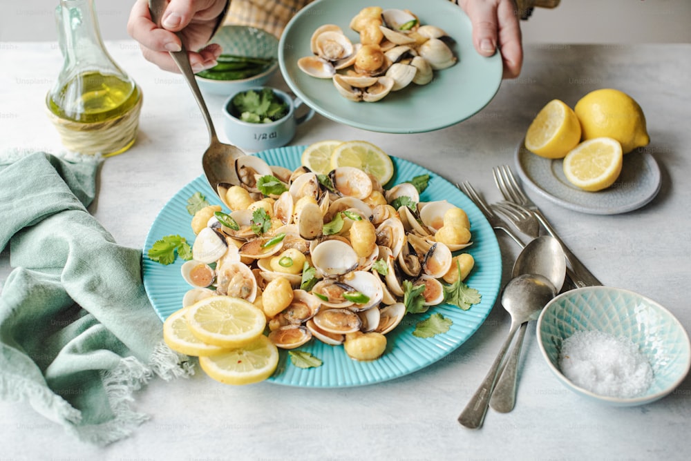 a plate of clams and lemons on a table