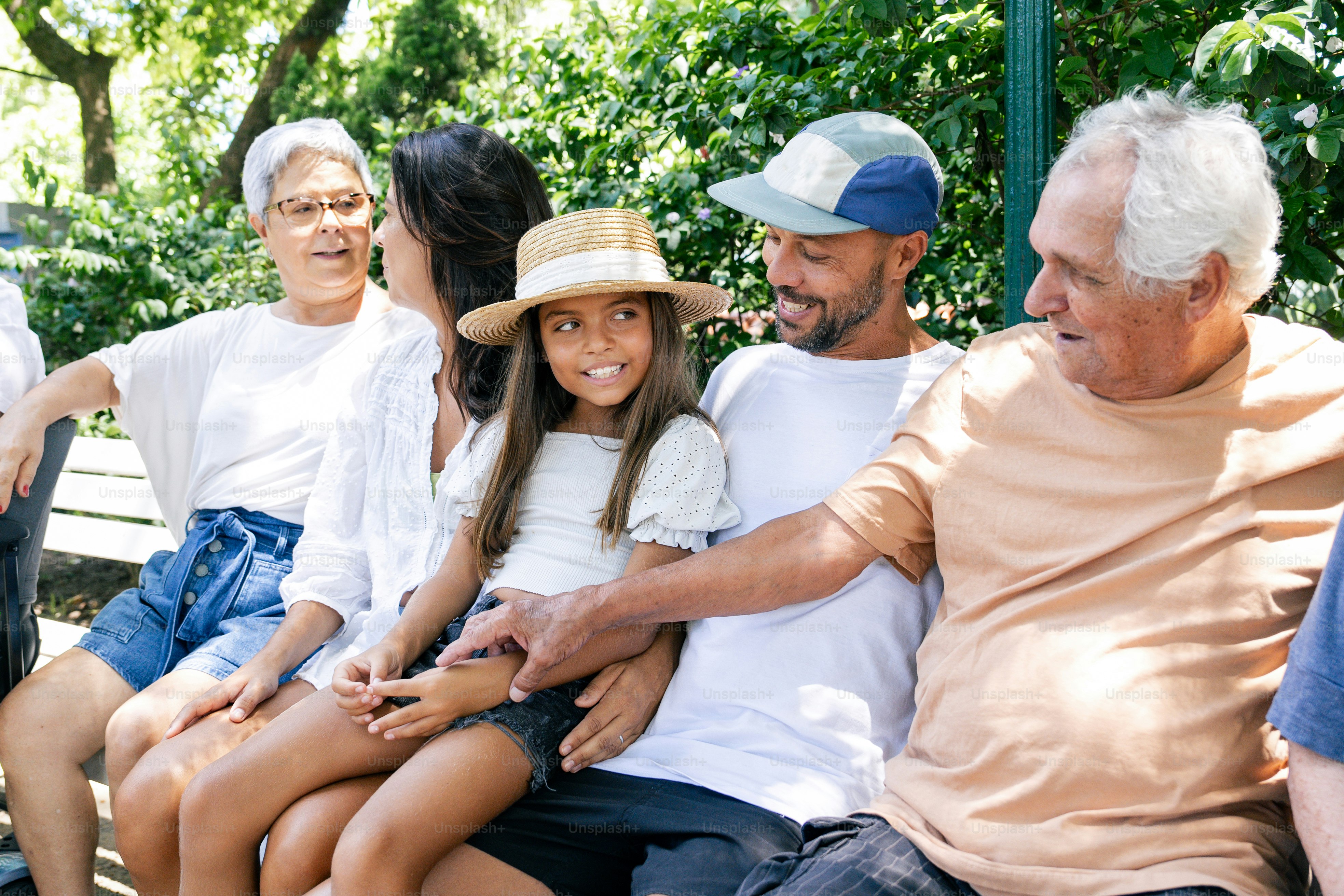 a group of people sitting next to each other on a bench