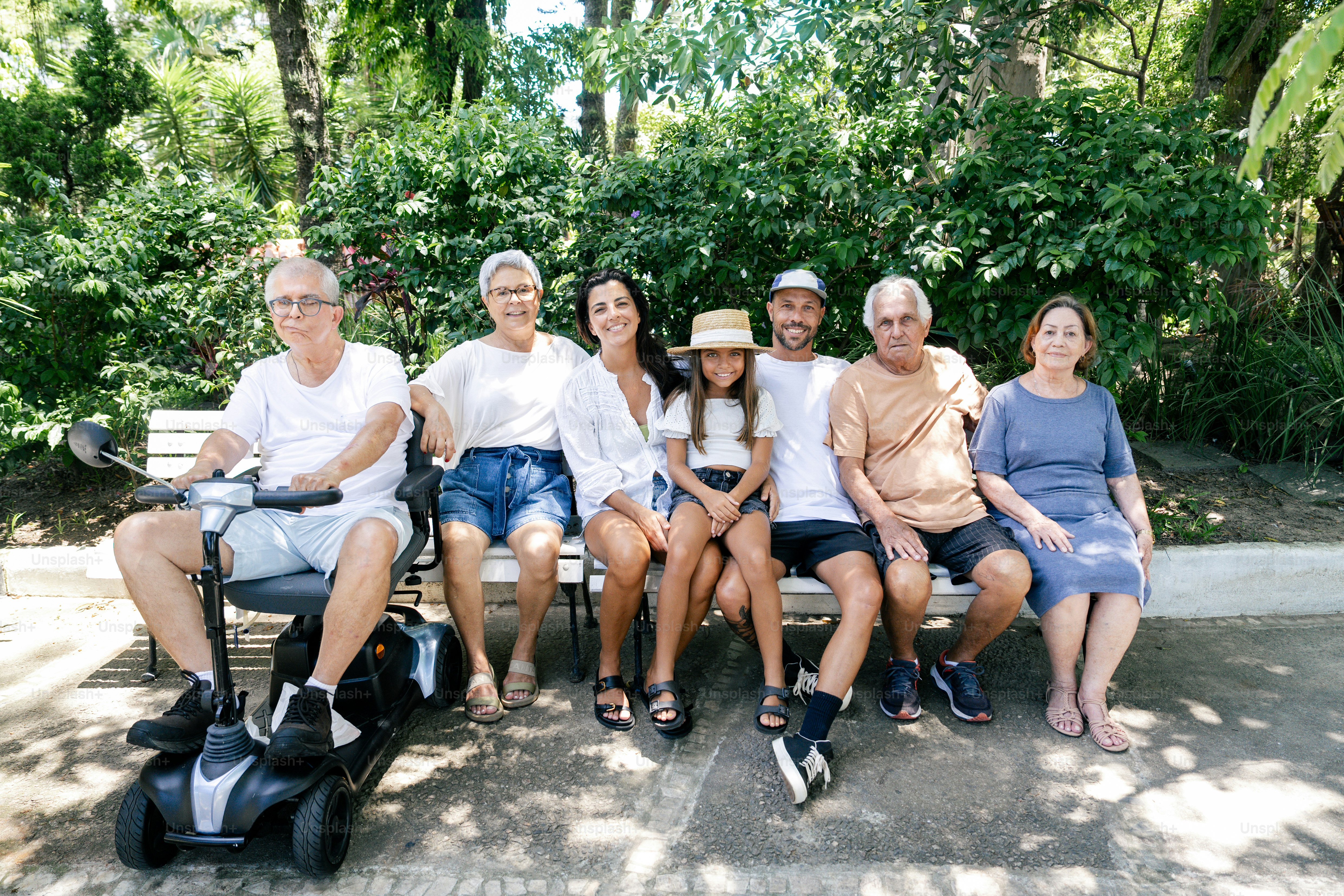 a group of people sitting on a park bench