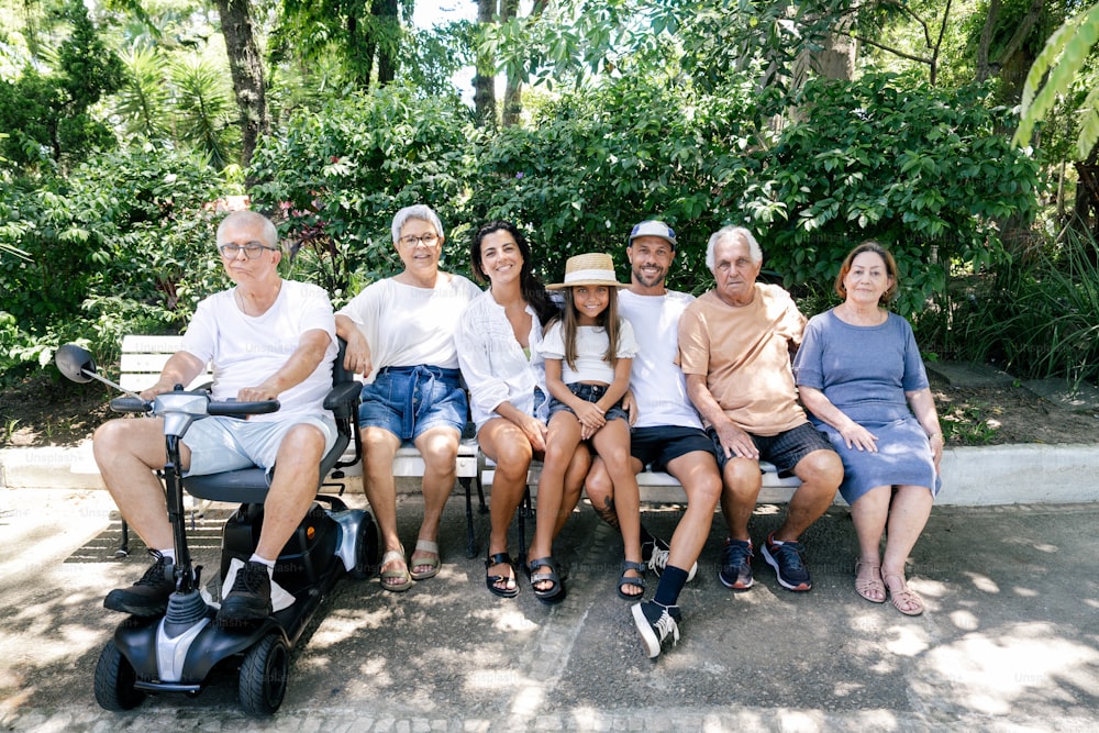 a group of people sitting on a park bench