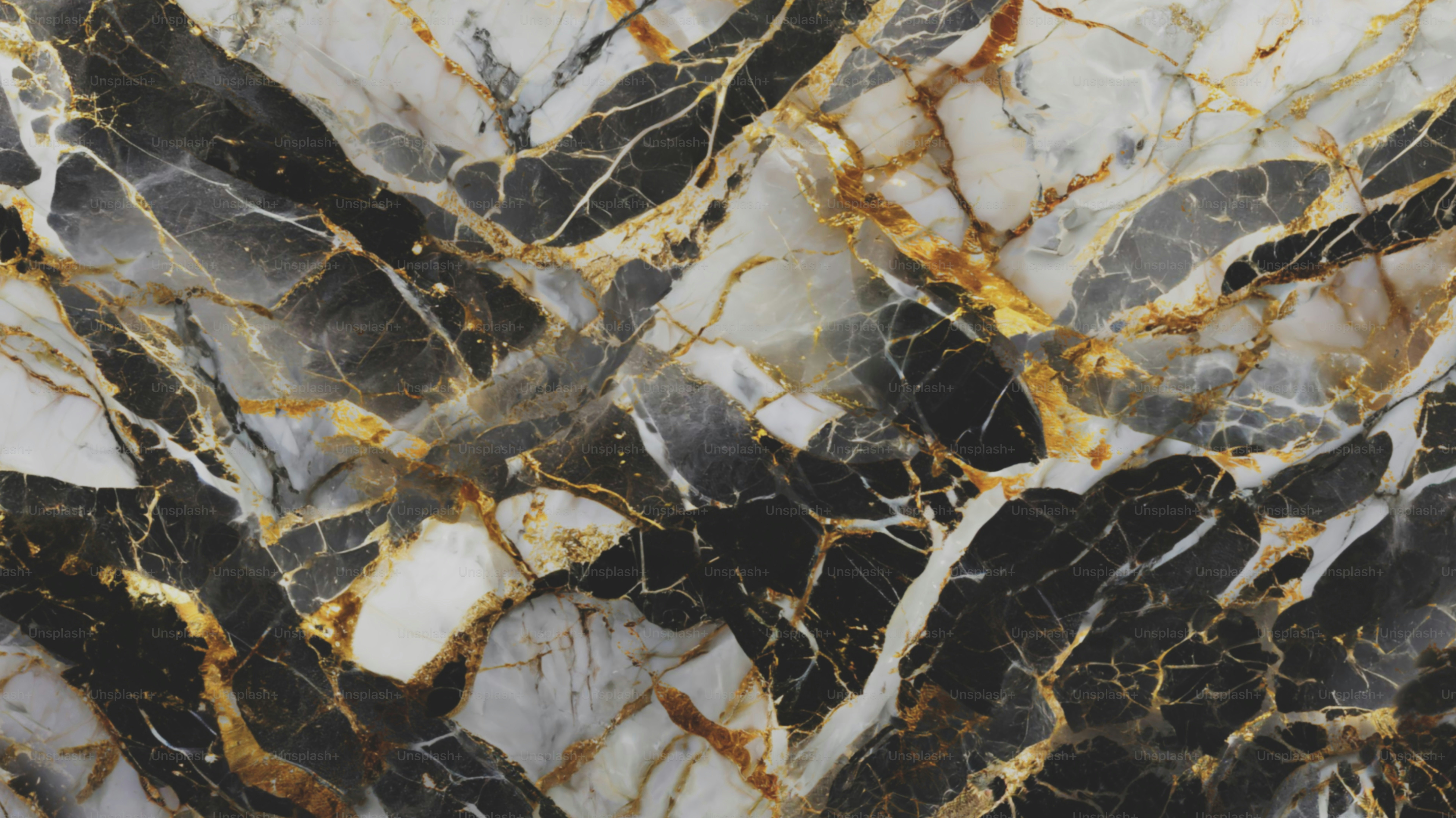 a black and white marble pattern with gold accents