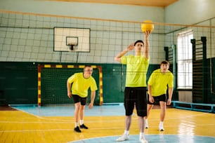 a group of young men playing a game of volleyball