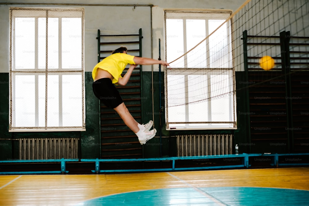 a person jumping in the air with a tennis racket