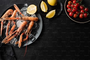 a plate of lobsters and lemons on a table
