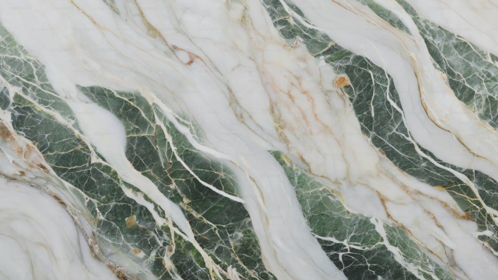 a close up of a marbled surface with green and white colors
