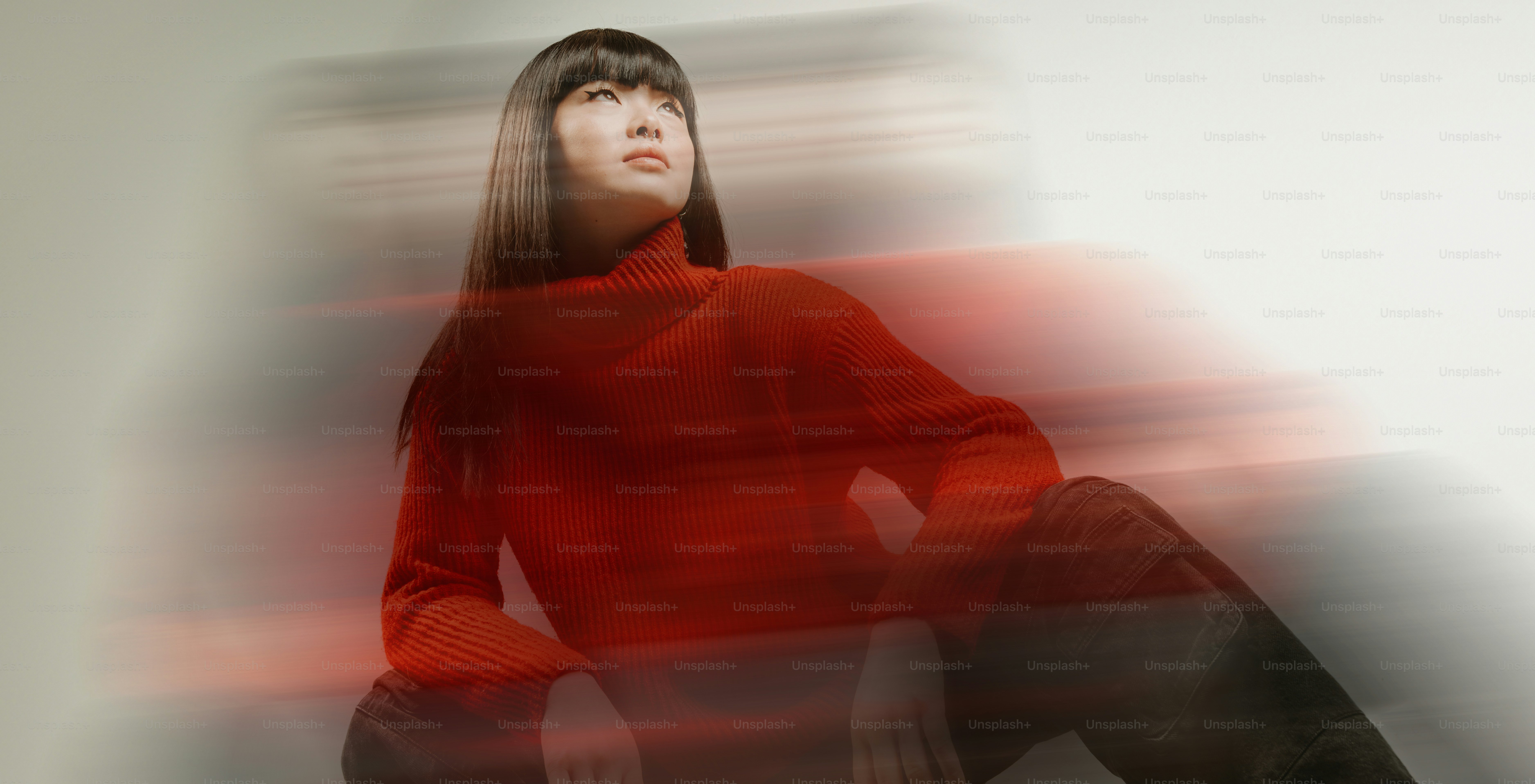 a woman in a red sweater and black pants