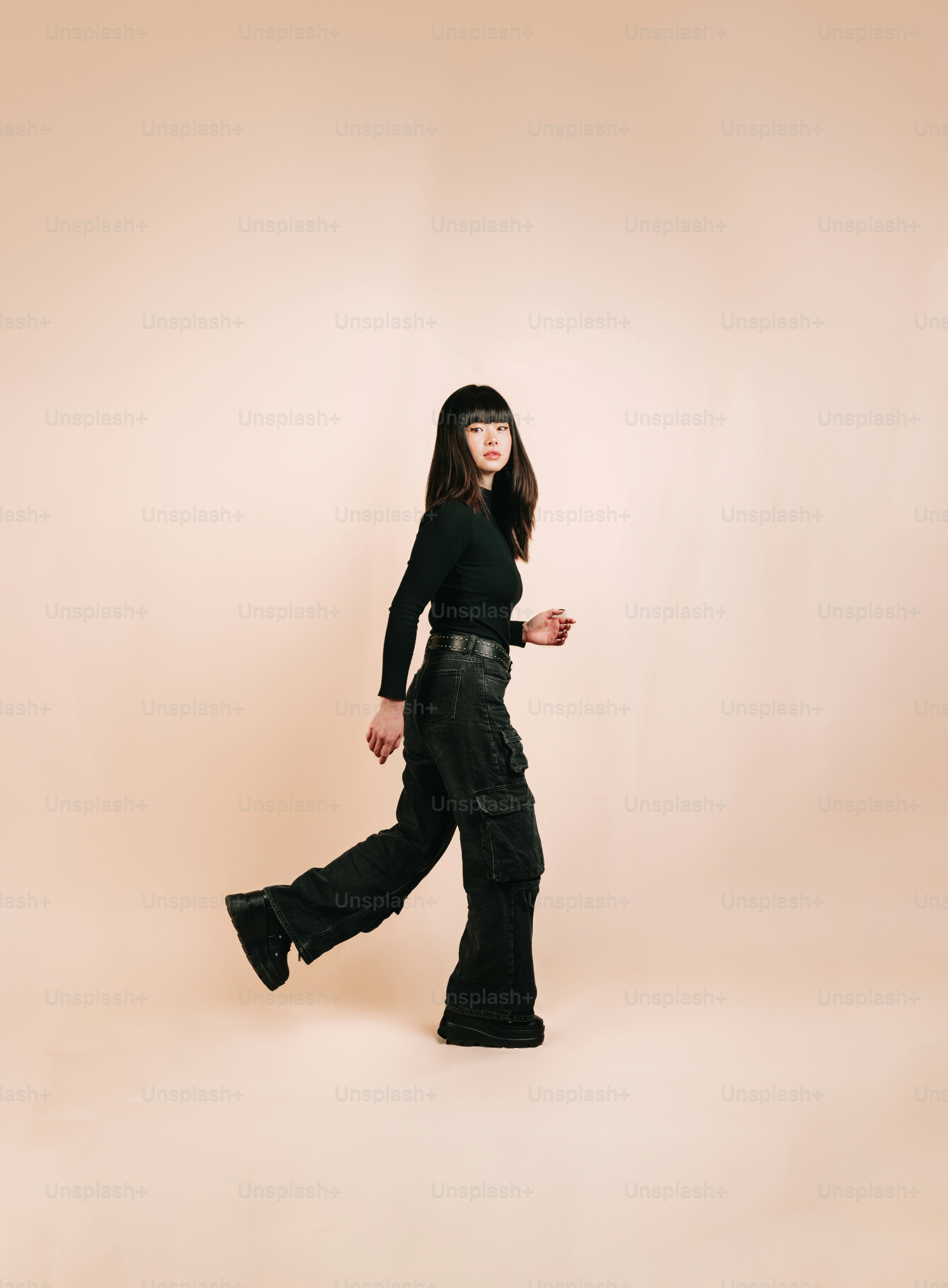 a woman in a black top and black pants