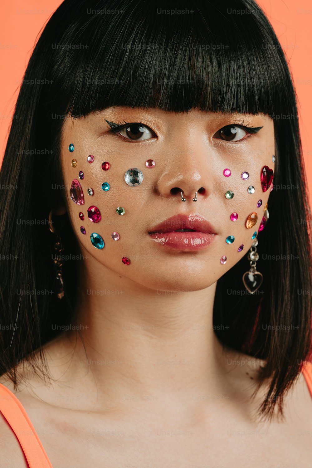 a woman with a face painted with jewels