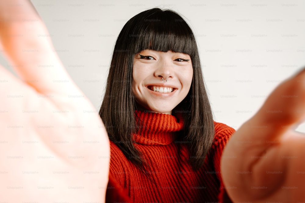 a woman in a red sweater is smiling