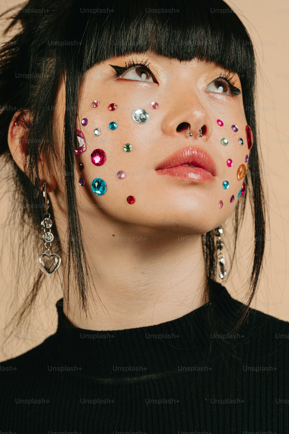 a woman with her face painted with jewels
