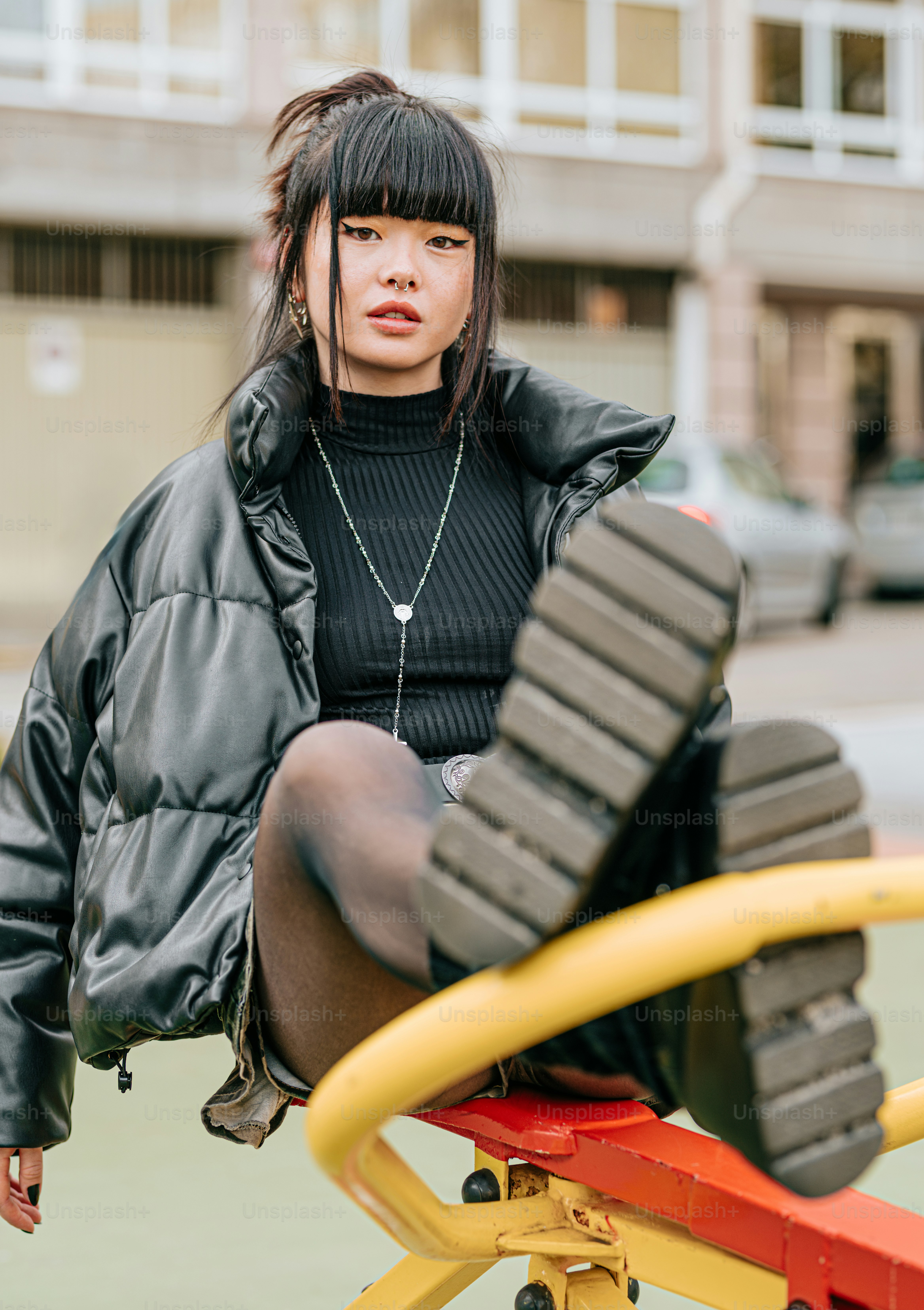 a woman sitting on top of a yellow bench