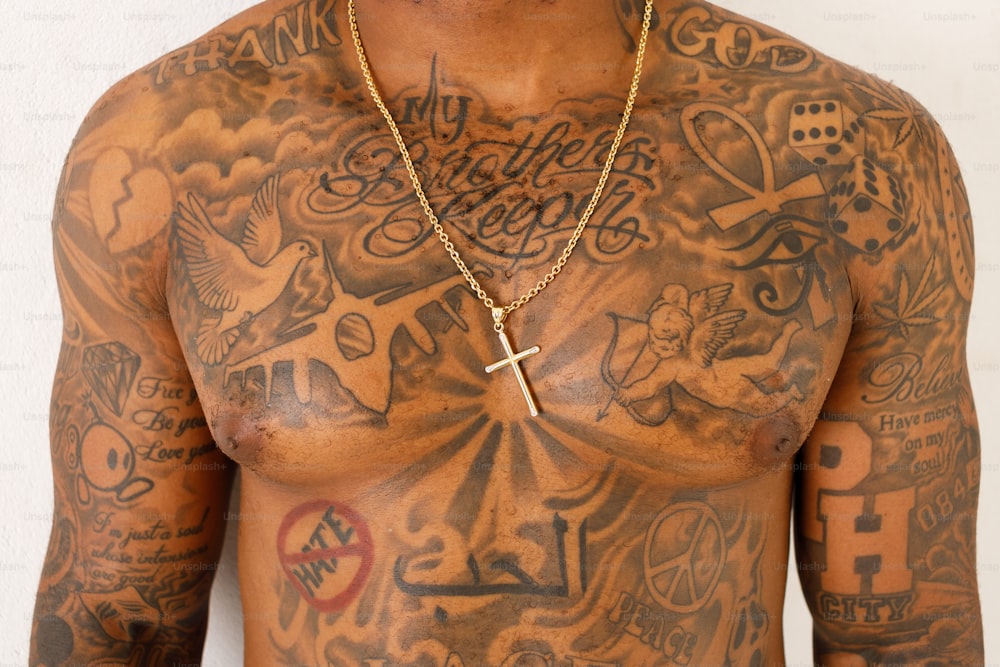 a man with a cross tattoo on his chest