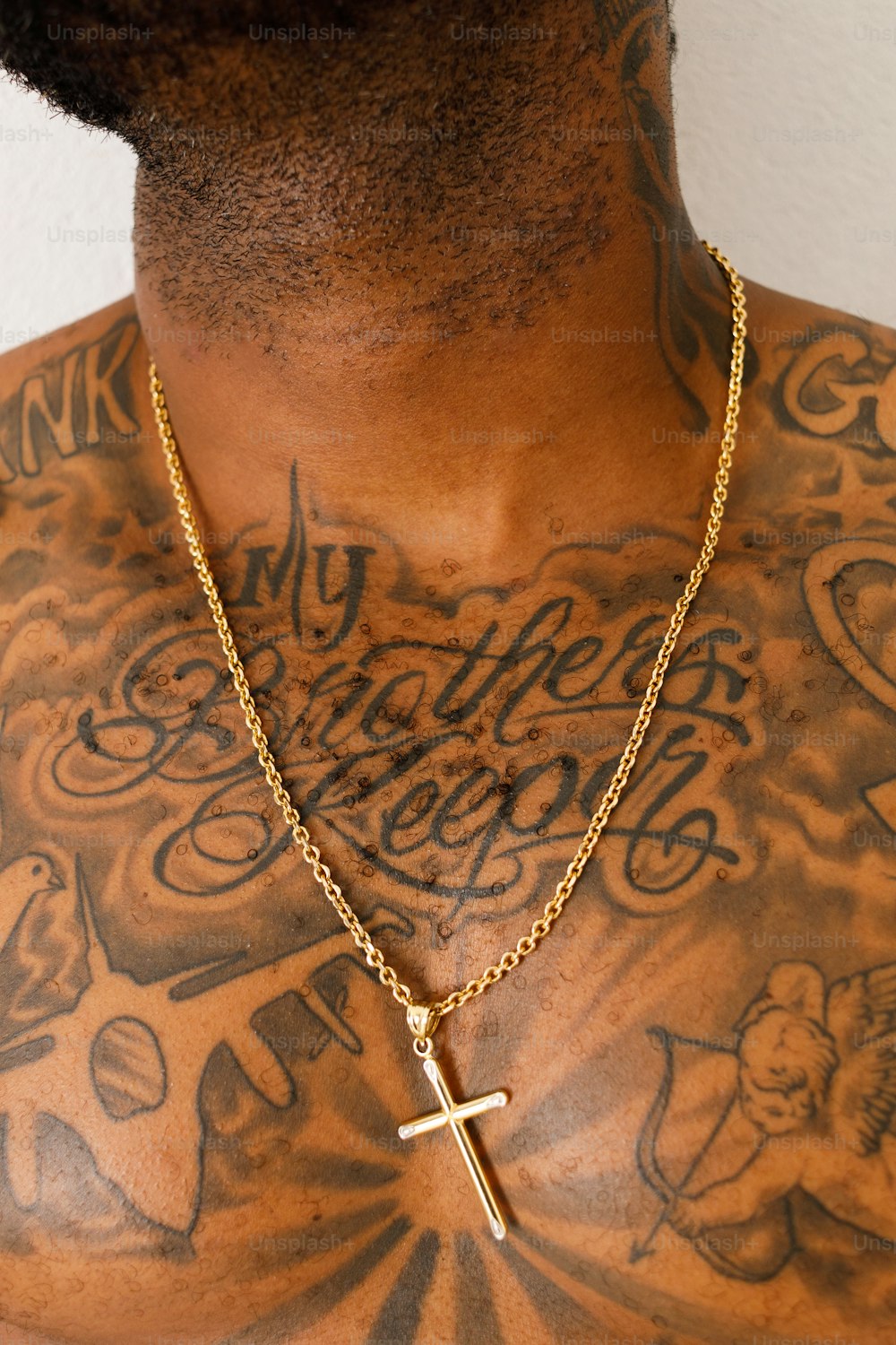 a man with a cross necklace on his chest