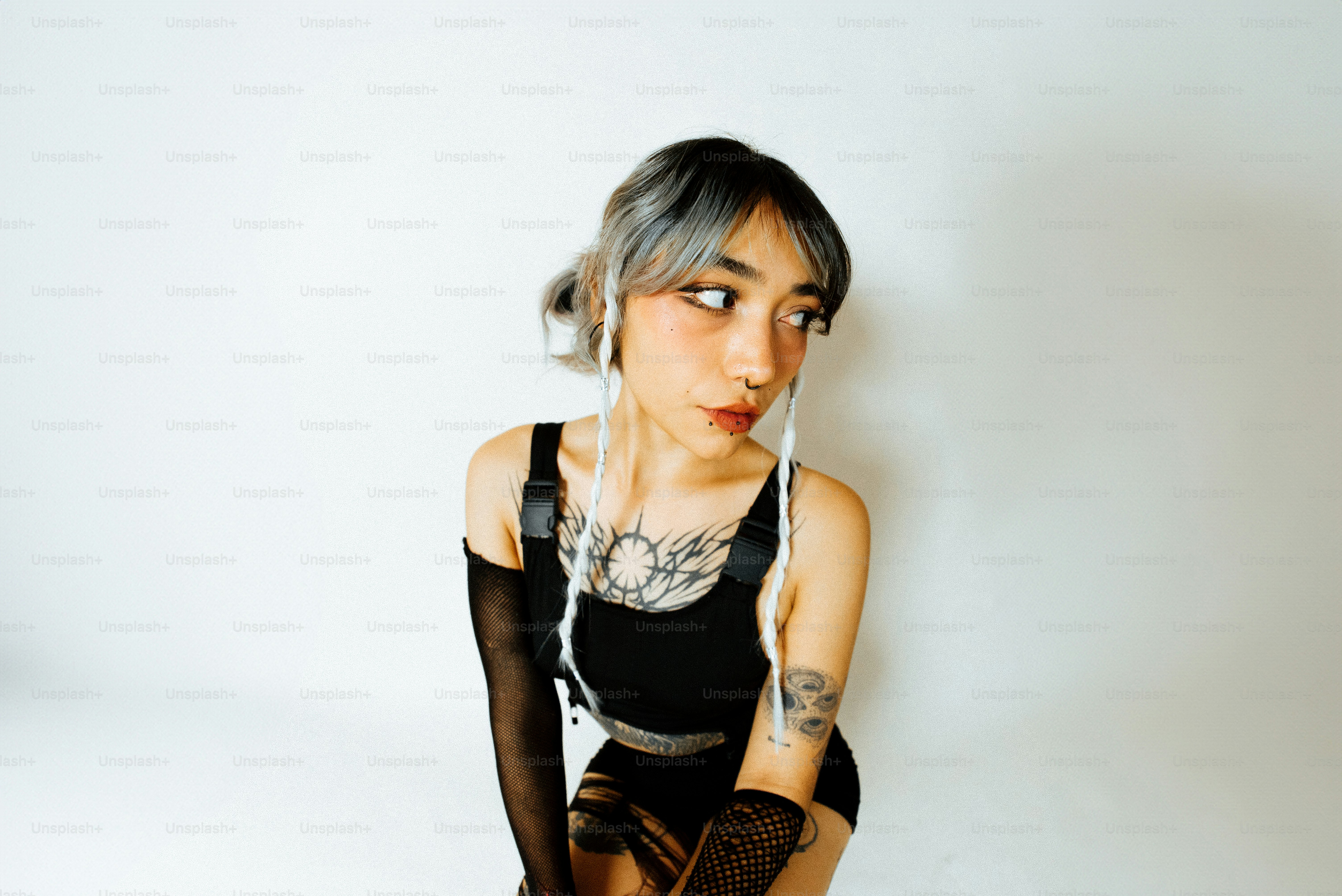 a woman with grey hair wearing black gloves