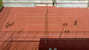 two people playing tennis on a tennis court