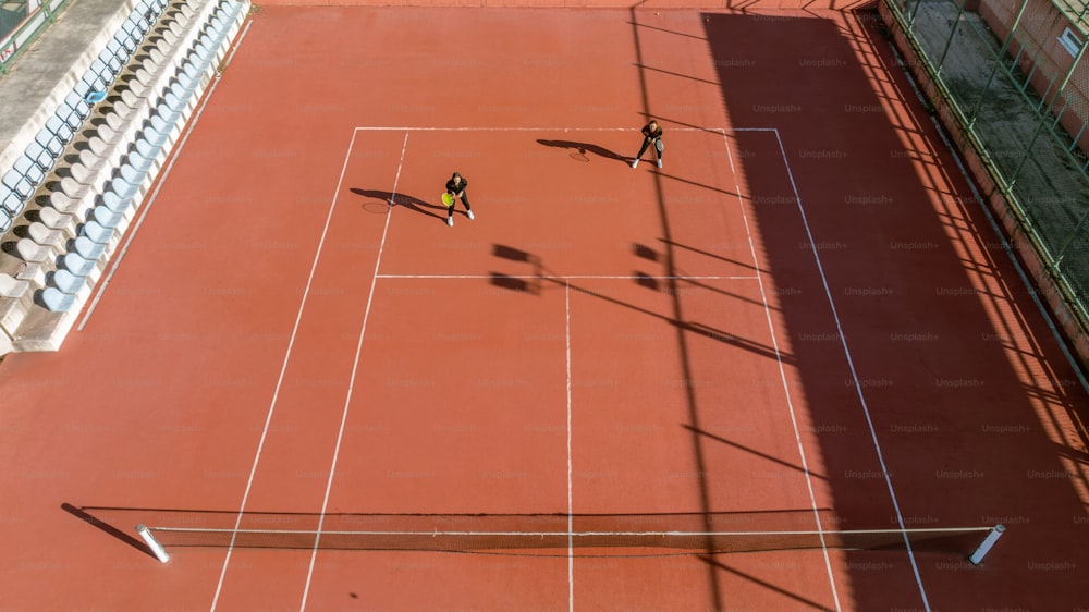 Due persone che giocano a tennis su un campo da tennis