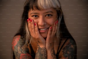 a woman with tattoos on her arms posing for a picture