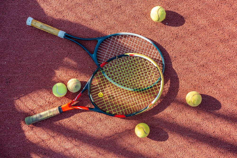 a tennis racket and tennis balls on a tennis court