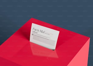 a red table with a white business card on it