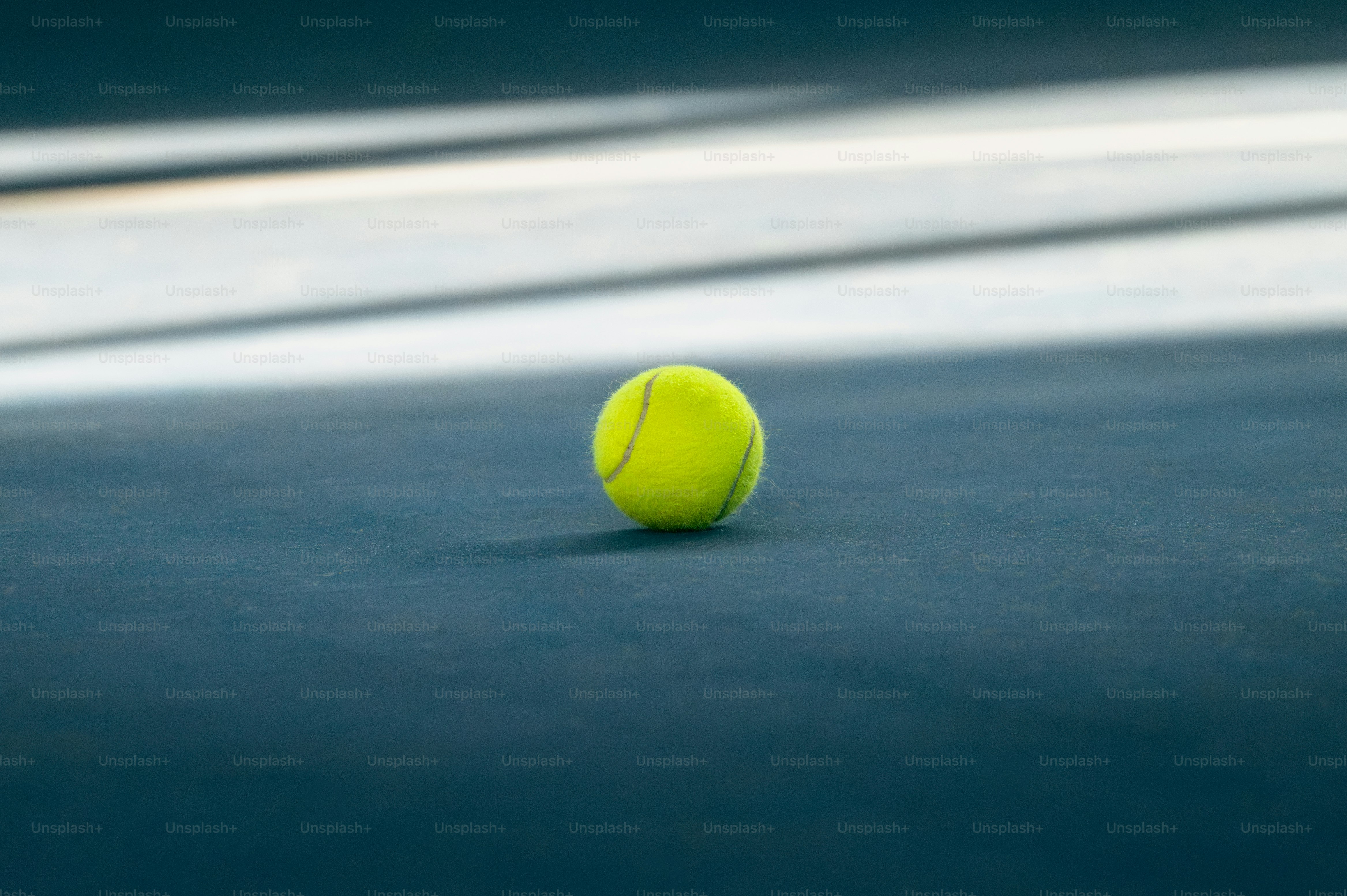 a tennis ball sitting on a tennis court