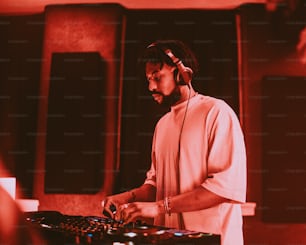 a man in headphones is mixing music